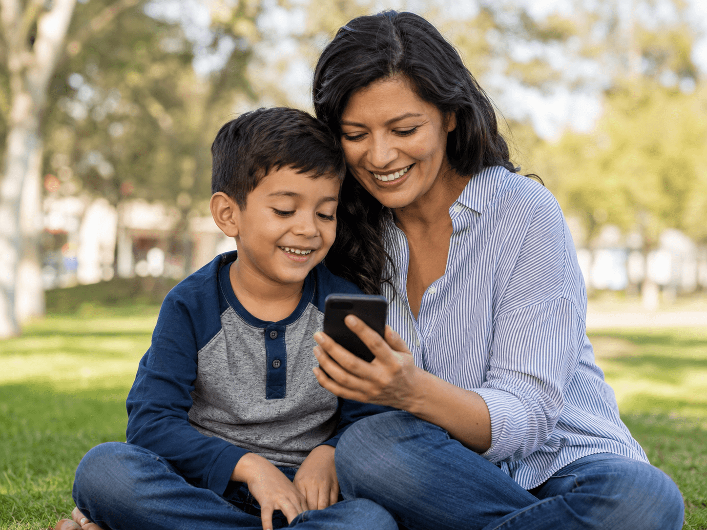 Parent and child reviewing information on a phone